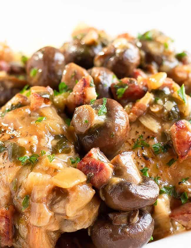 Chicken with Sherry Mushrooms Sauce piled high on a white plate.