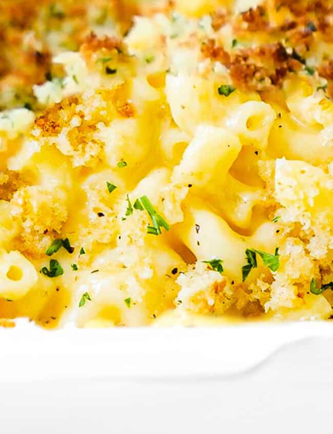 a close up image of a pan of Creamy Baked Mac and Cheese.