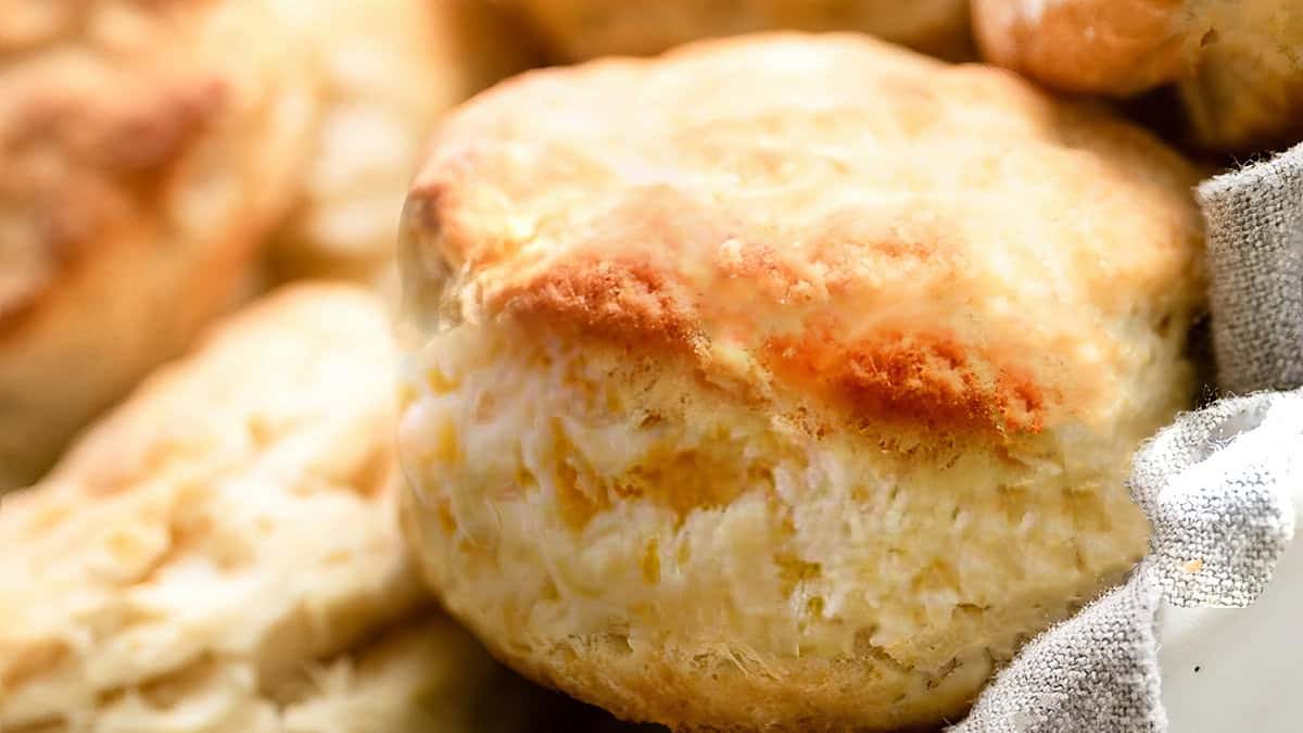 A close up of a freshly baked Buttermilk Biscuits in a basket.