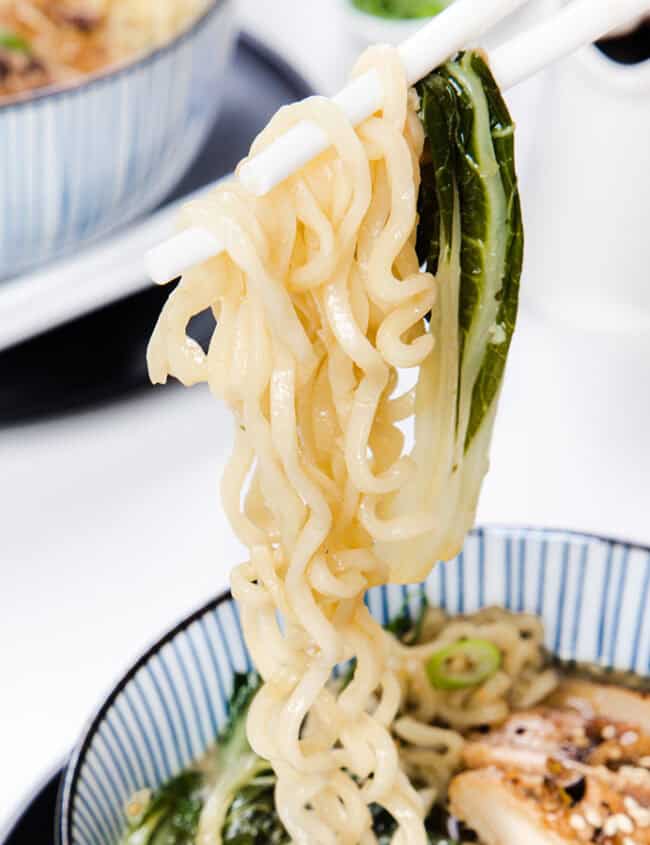 Miso Ramen being lifted from a bowl with chopsticks.