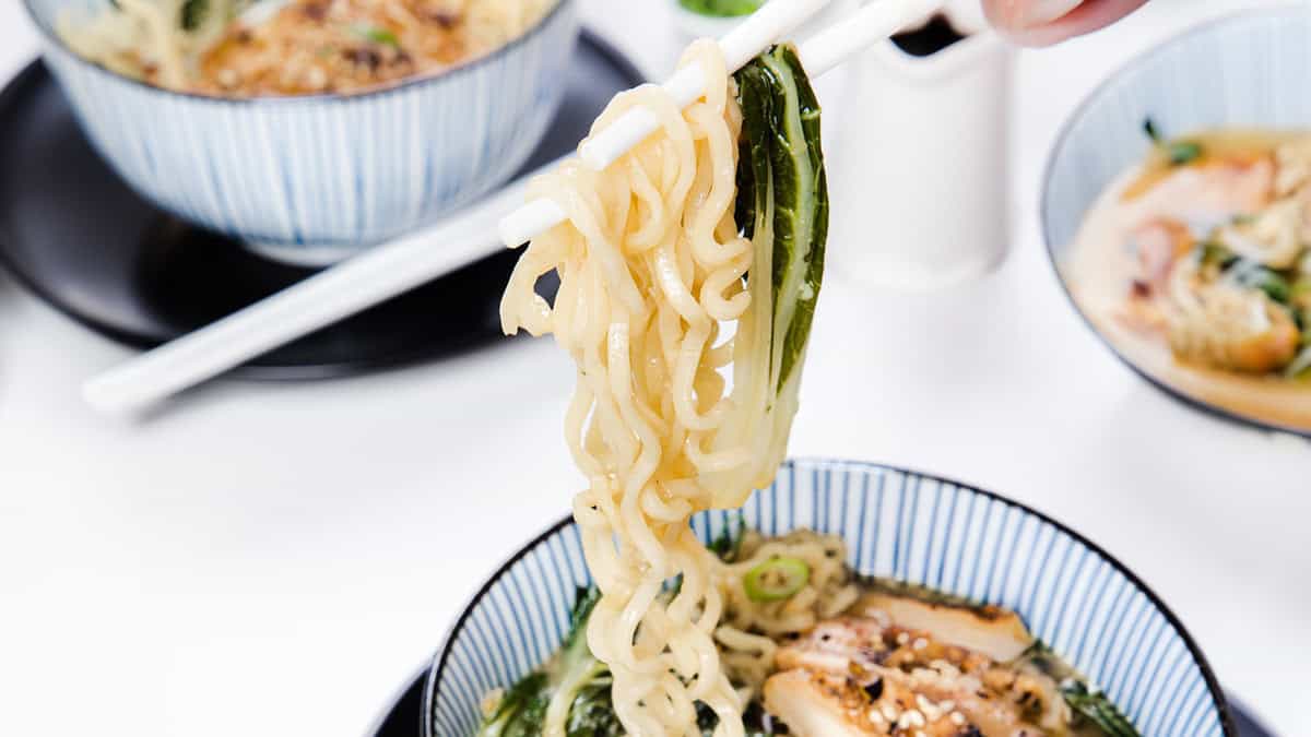 Miso Ramen being lifted from a bowl with chopsticks.