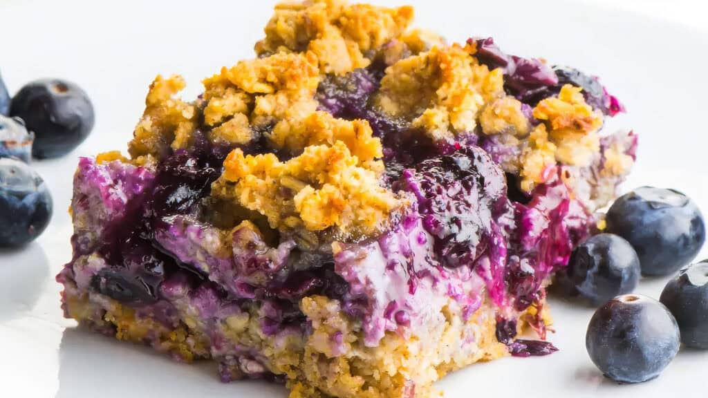 A close up image of Blueberry Oat Bars with a blueberry filling.