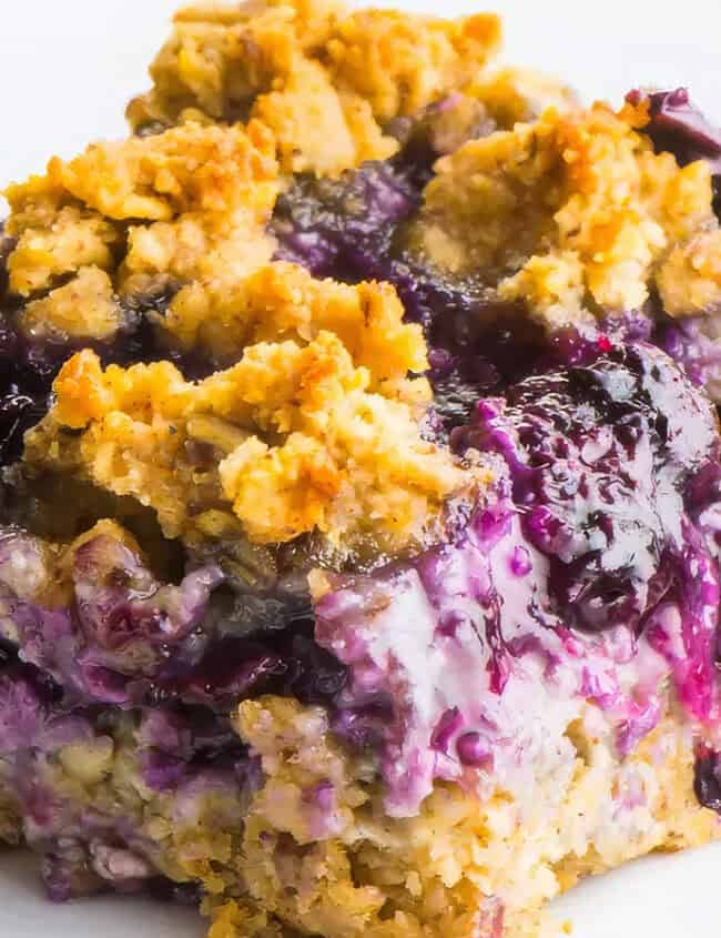 A close up image of Blueberry Oat Bars with a blueberry filling.