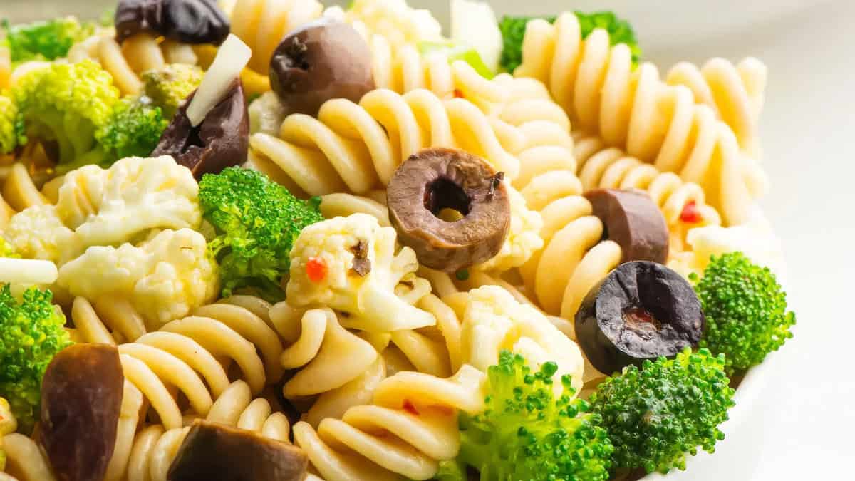 A close up image of Vegan Pasta Salad with broccoli and sliced olives.