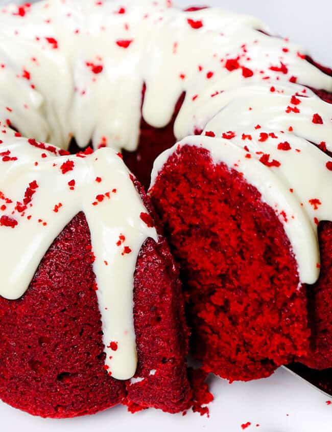 A slice of Red Velvet Bundt Cake being removed with a cake server.