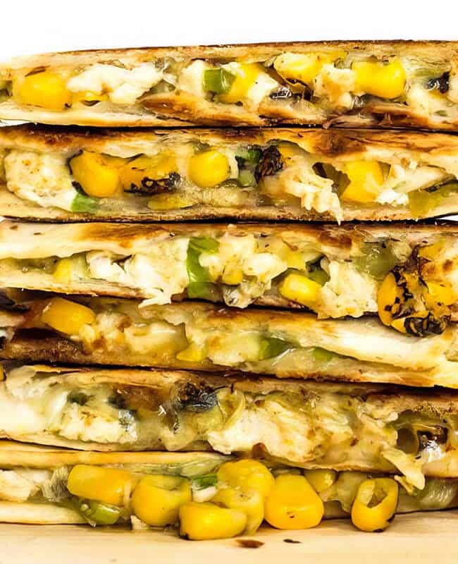 A close up image of Roasted Corn Quesadillas stacked in a pile.