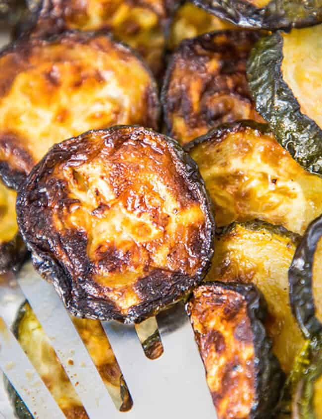 Roasted sliced zucchini in a pan.