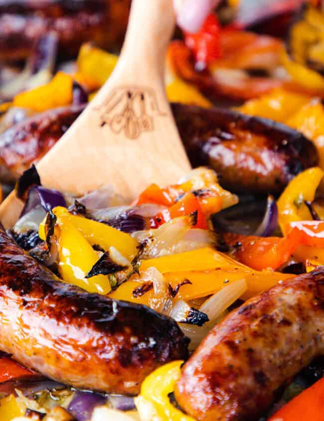 a close up image of Italian Sausage and Peppers on a sheet pan ready to serve.