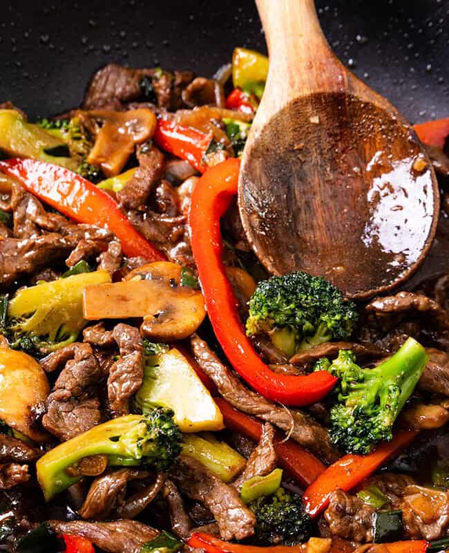 a close up image of a steak stir fry in a wok.