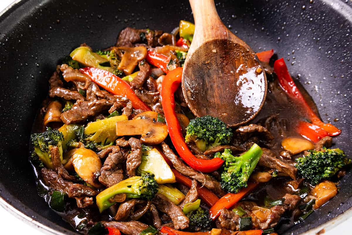 a close up image of a steak stir fry in a wok.