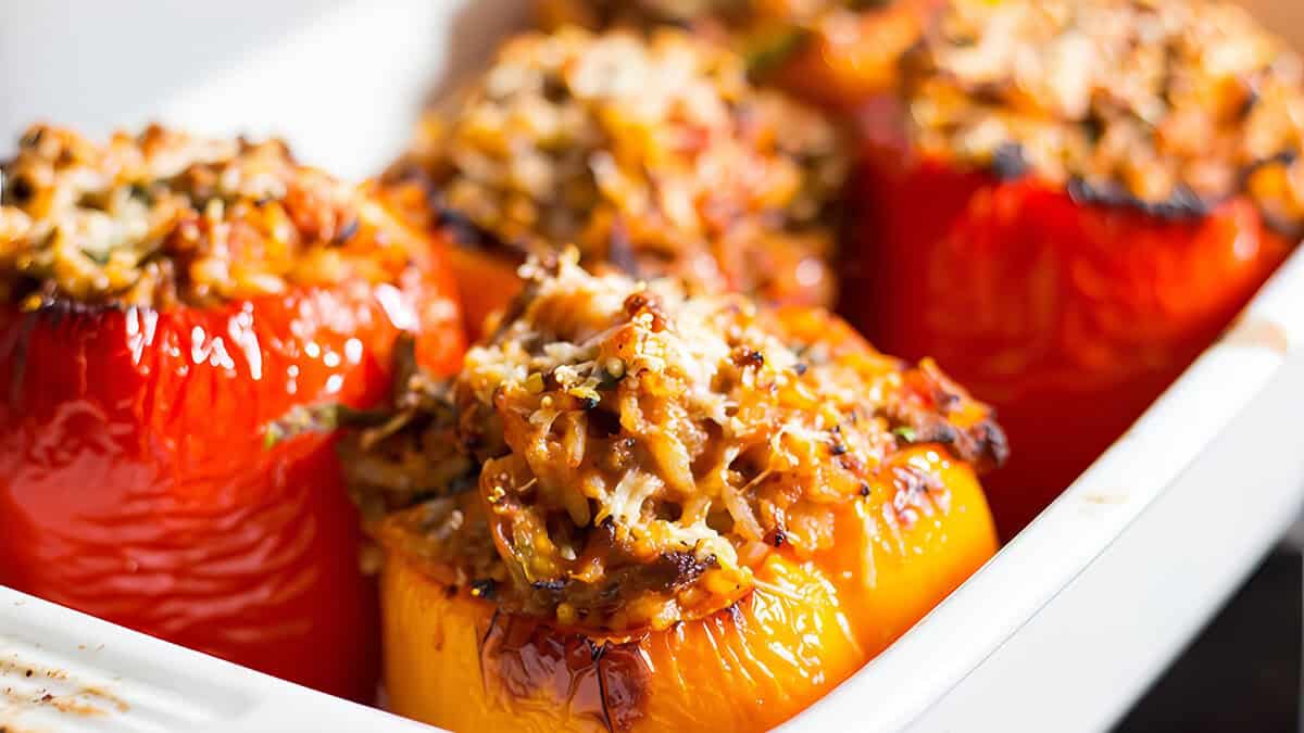 Stuffed peppers right out of the oven with golden tops.