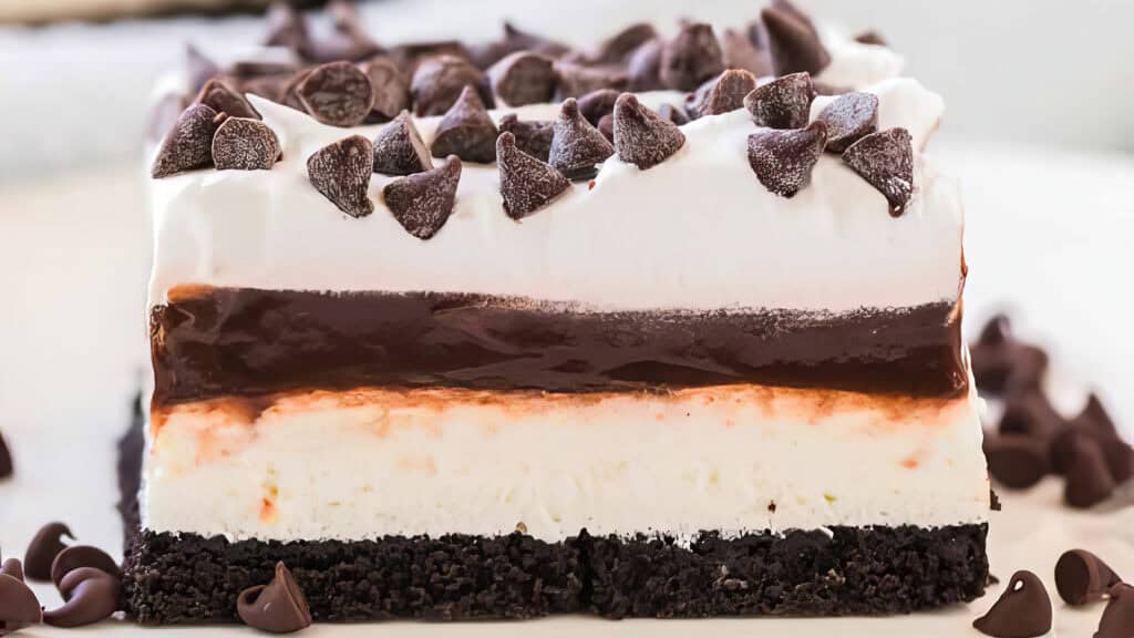 A close up image of Chocolate Lasagna with a cookie crust and creamy and chocolate layers.