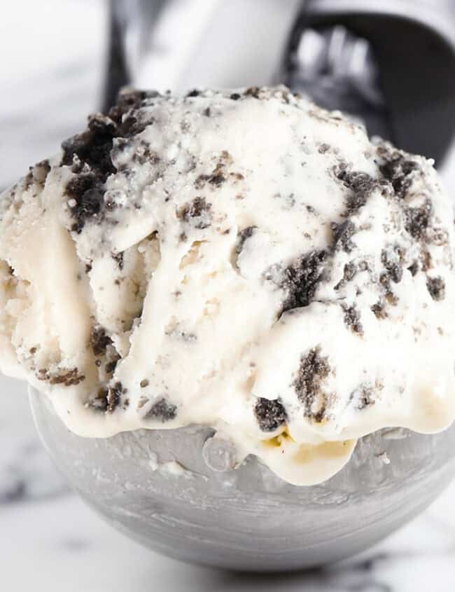 A close up image of cookies and cream Ice Cream in an ice cream scoop.