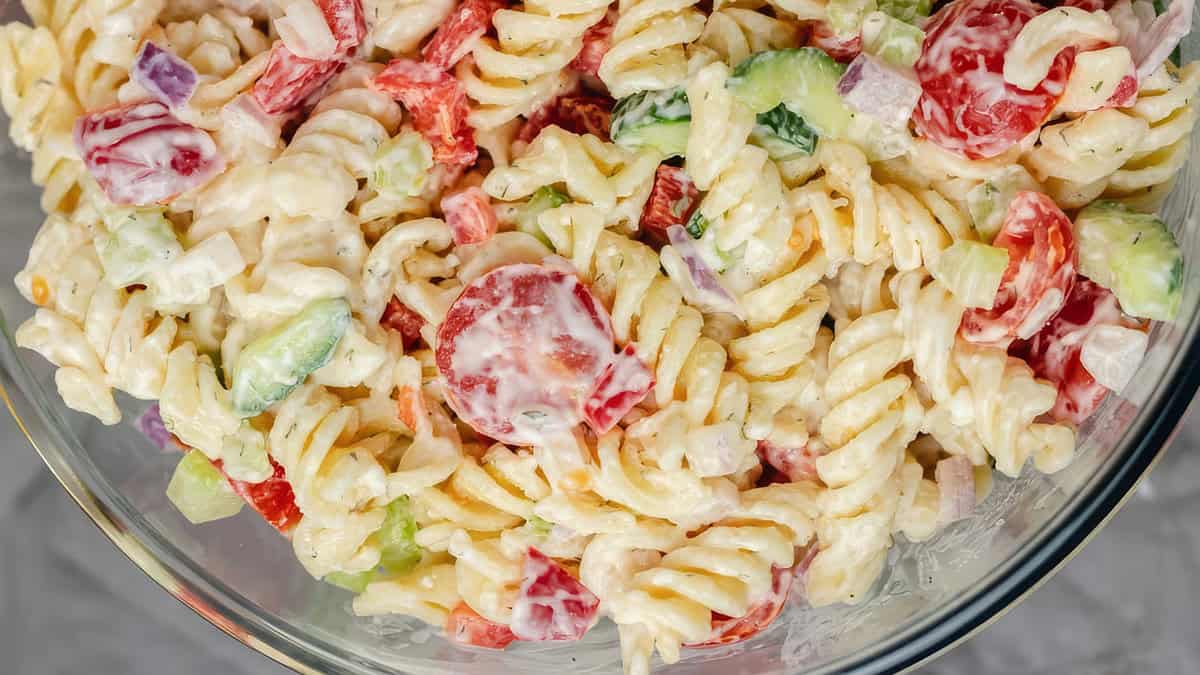 A close up image of Pasta Salad with a creamy dressing.