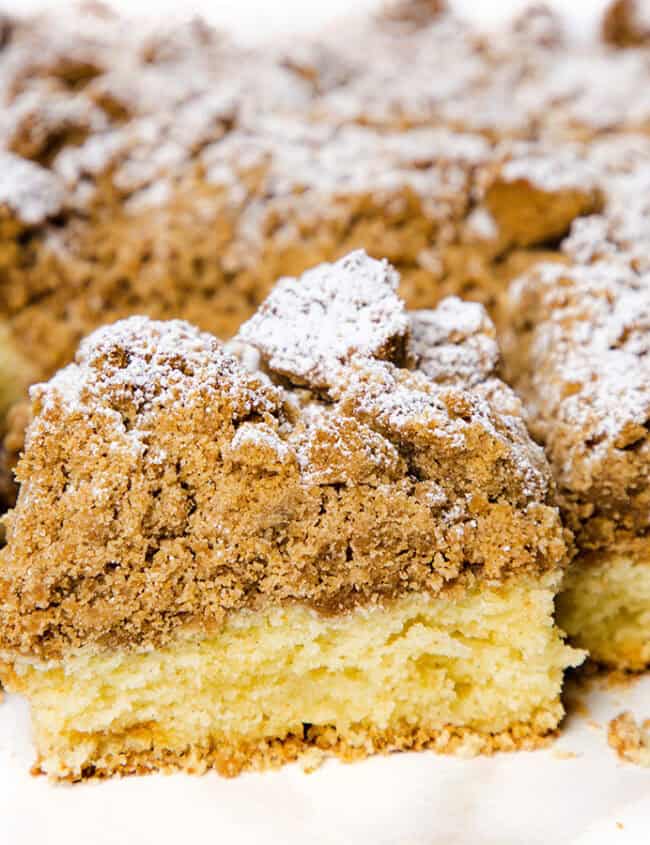 A Crumb Coffee Cake with a slice cut from it.