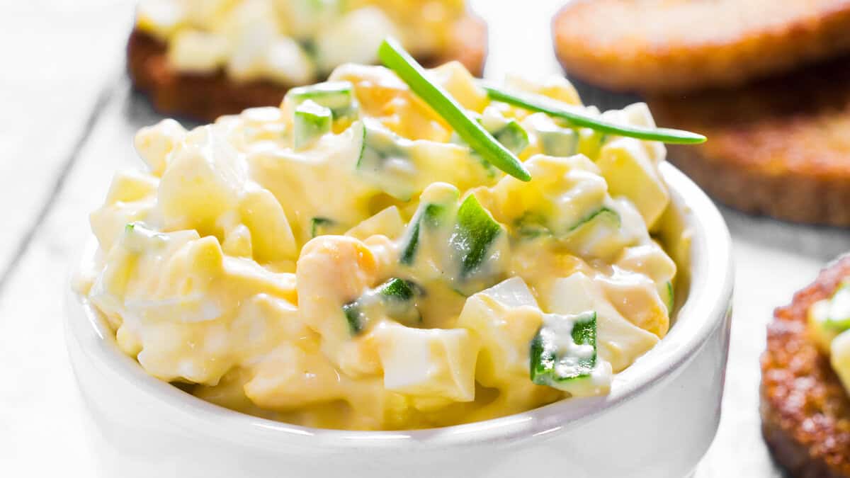 A close up image of egg salad with chives