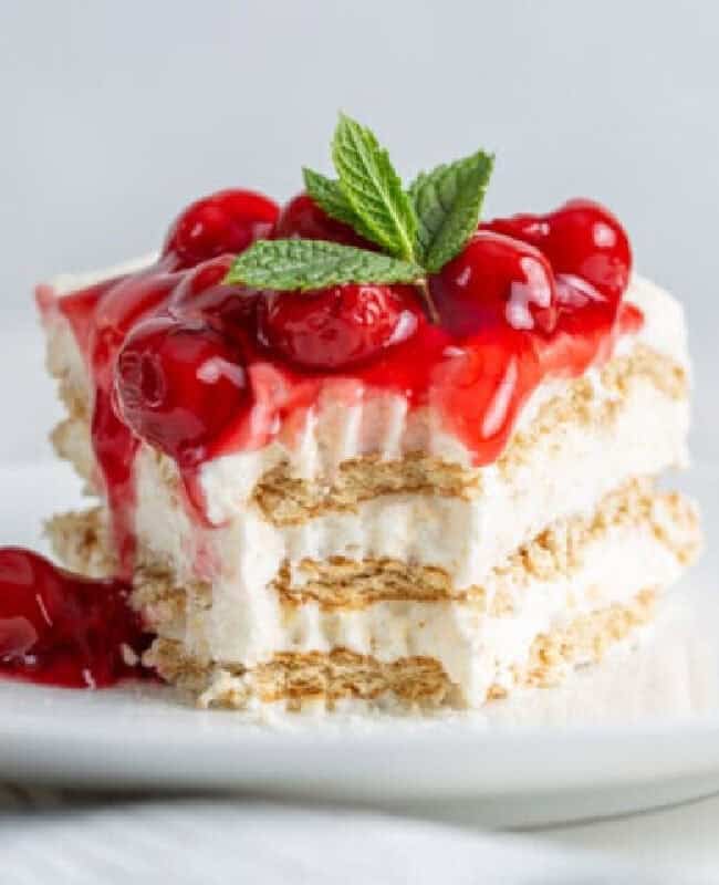 A slice of No Bake Cherry Cheesecake Icebox Cake with a forkful cut from it.