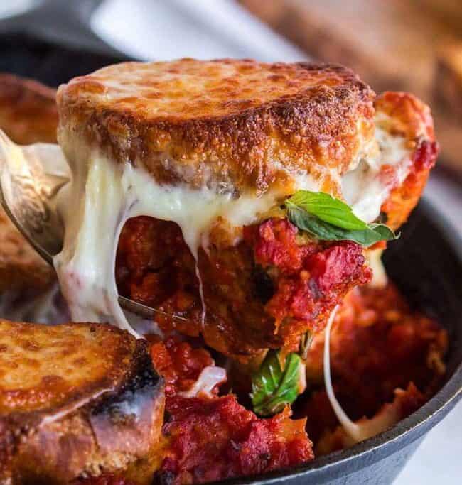 A close up image of a slice of Meatball Sub Casserole being served.