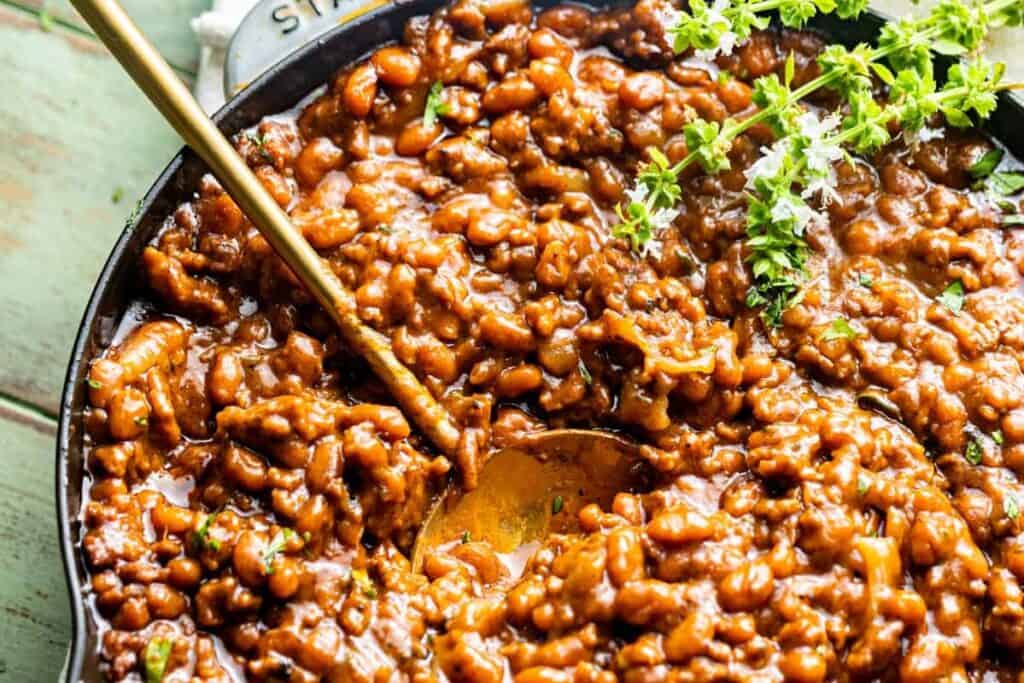 A pan full of Baked Beans with Ground Beef. 