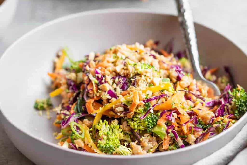 a colorful Summer Farro Salad in a white bowl.