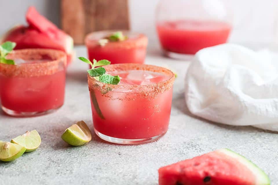 A tray of Watermelon Palomas with slices of watermelon.
