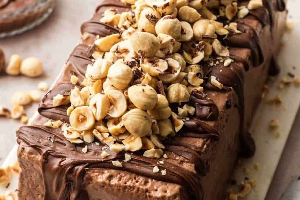 A close up image of Chocolate Semifreddo topped with chopped hazelnuts.