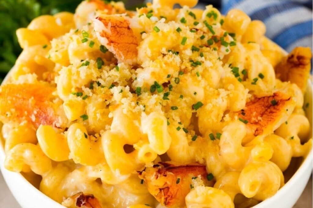 A close-up of a bowl of macaroni and cheese topped with crab meat.