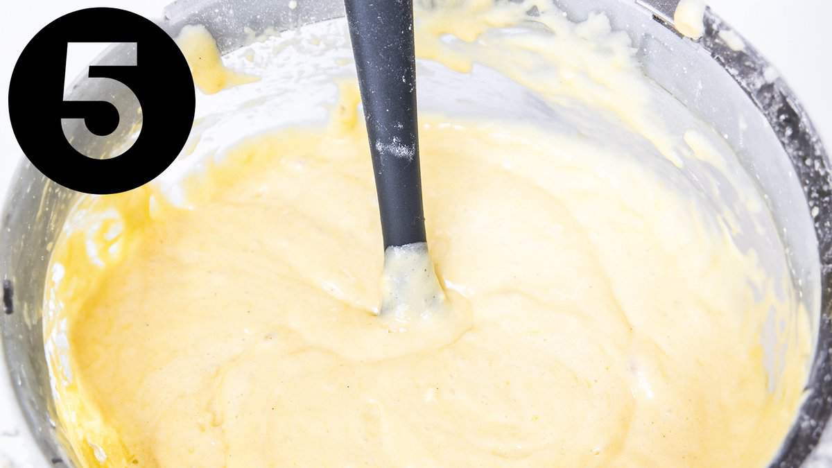 A bowl of batter with a spatula in it.