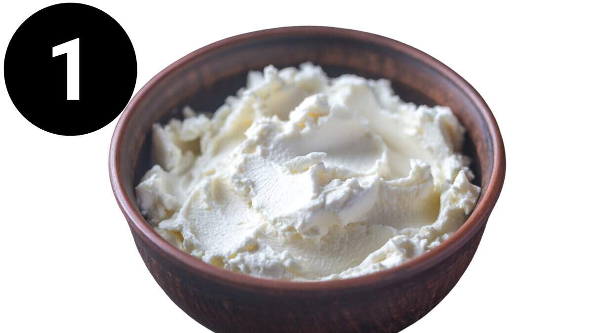 A bowl of softened cream cheese.