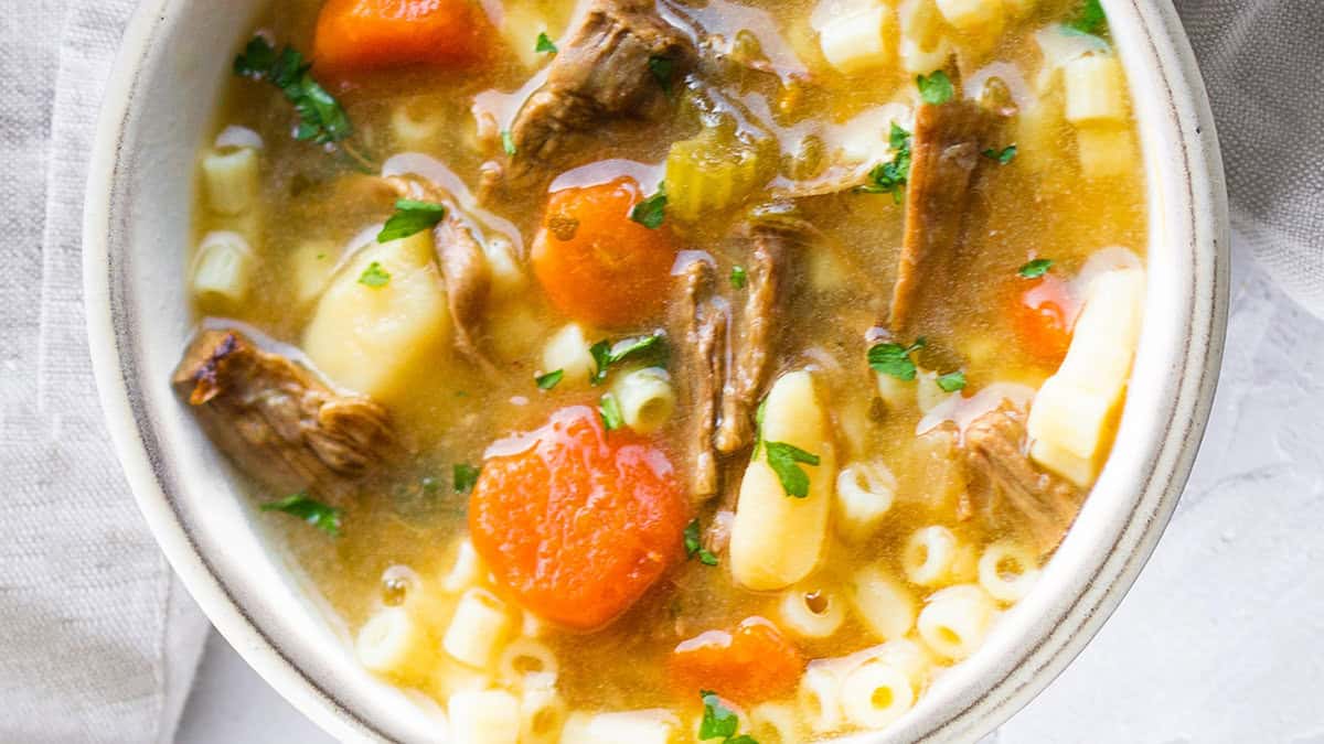 A white bowl filled with brisket soup.