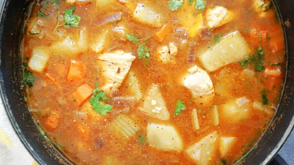 An overhead image of a pot of Chicken and Potato Stew.