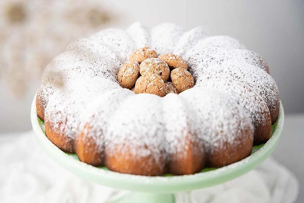 A close up of a Italian Lemon Ricotta Amaretti Budino filled with Italian cookies.