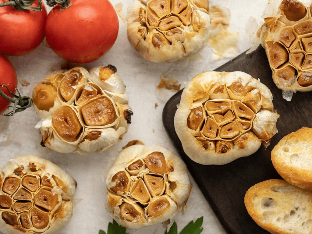 A platter of golden Roasted Garlic heads.