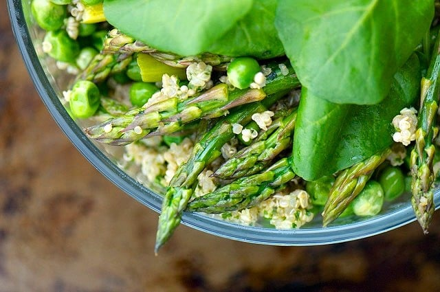 A close up of Quinoa Pesto Bowl with asparagus and herbs