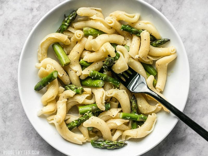 A plate of Asparagus Pasta With Lemon And Garlic with a fork on the plate.