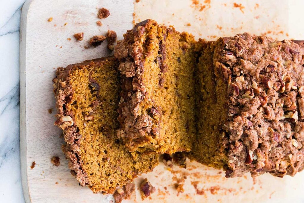 A close up image of a sliced Sweet Potato Crumb Cake with Pecan Cinnamon Swirl. 