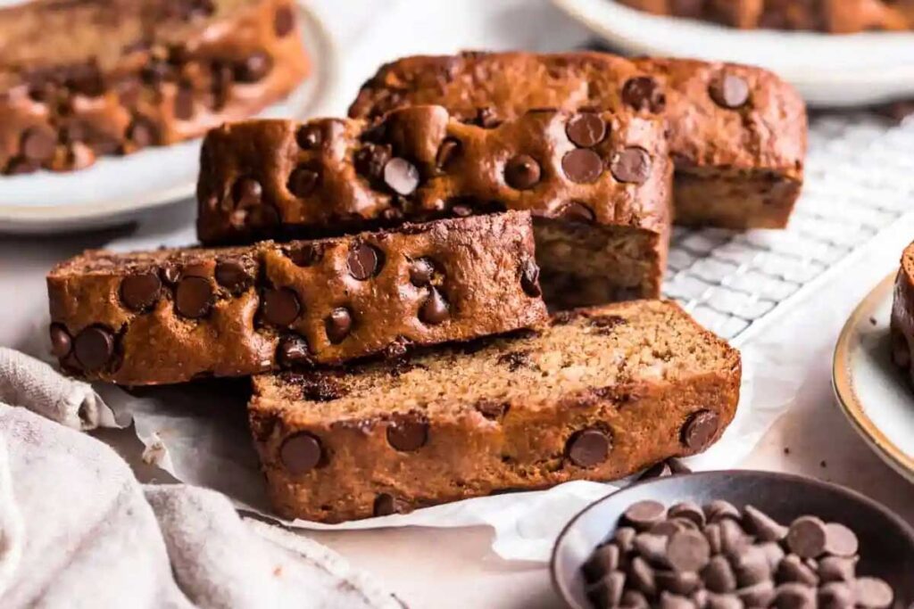 A close up image of three stacked sliced of Almond Butter Banana Bread with chocolate chips.