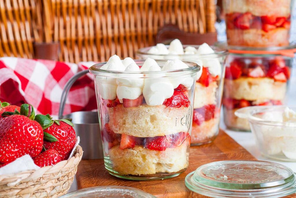 Strawberry Shortcake in a Jar arranged with a picnic bascket.