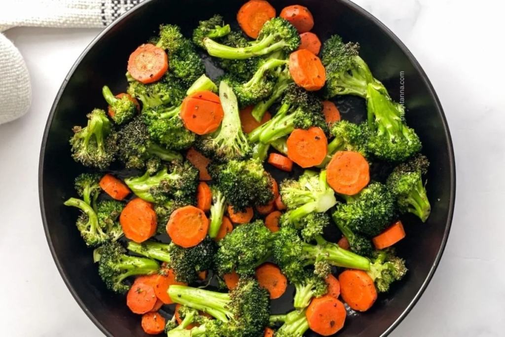 A pan full of Easy Air Fryer Roasted Carrots and Broccoli.