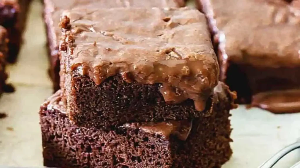 Two peices of Chocolate Condensed Milk Cake stacked.