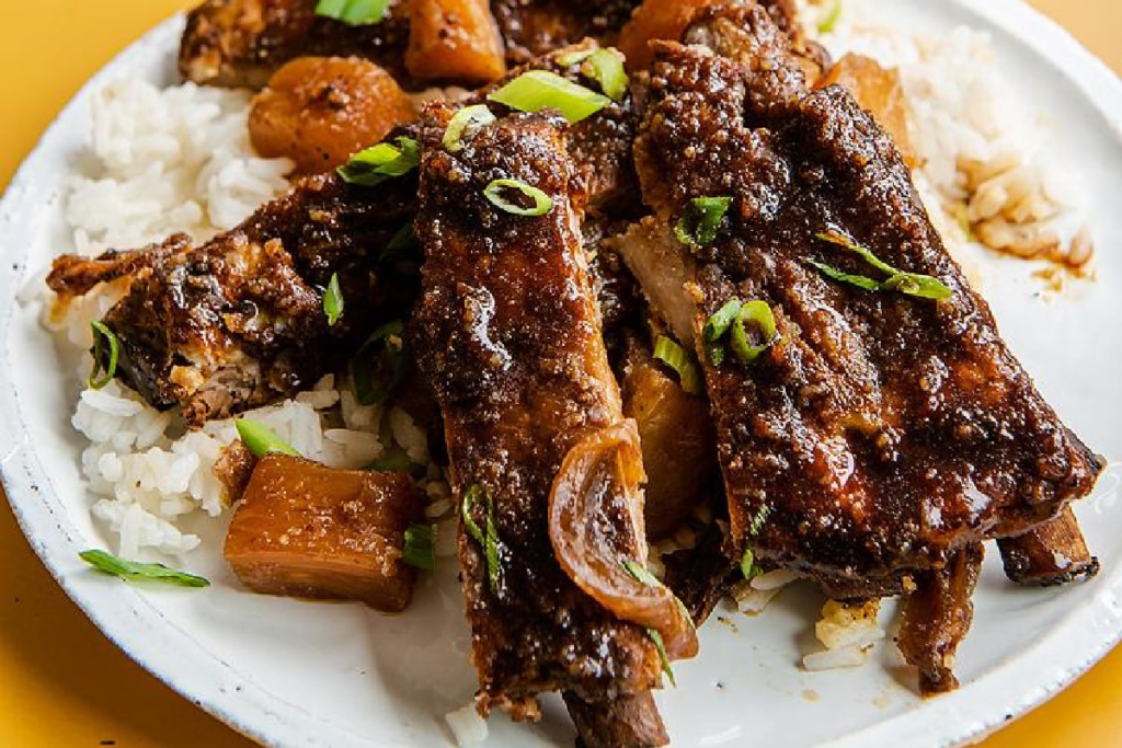 a close up image of Slow Cooker Hawaiian Ribs on top of rice.