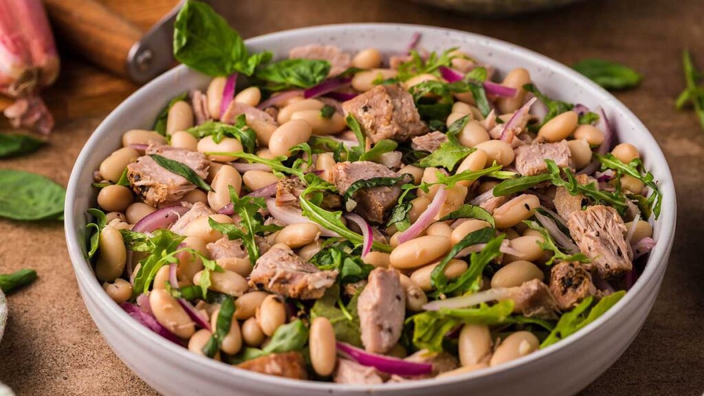 A close up image of a bowl of Italian Tuna White Bean Salad. 