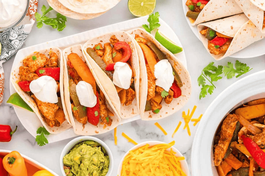 Crockpot Chicken Fajitas. displayed like tacos on a platter.