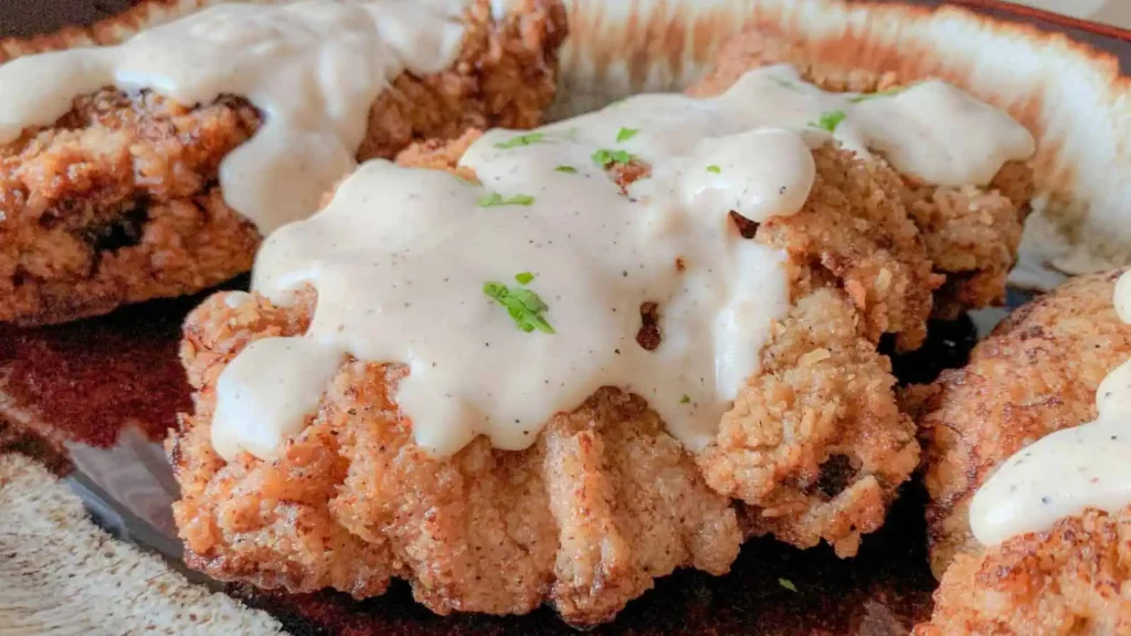 Country Fried Steak topped with creamy gravy.