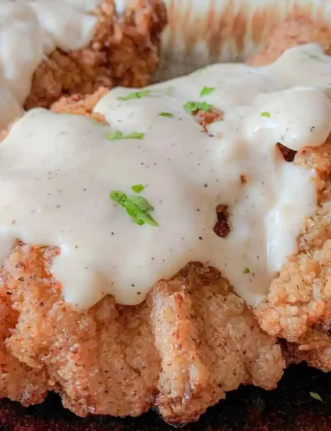 Country Fried Steak topped with creamy gravy.