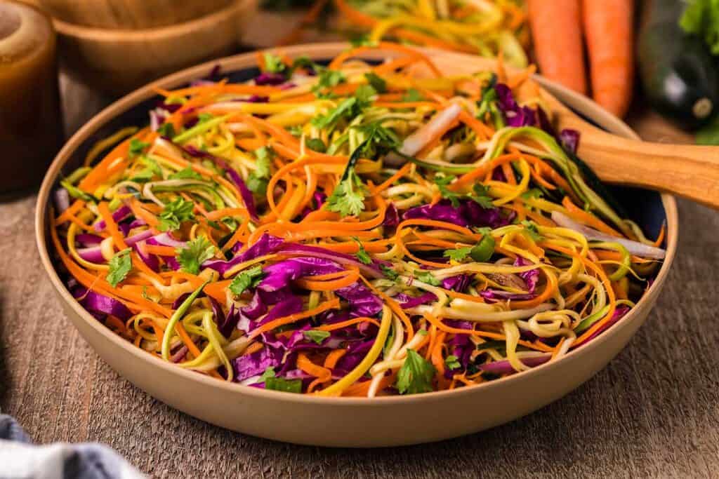 Asian Zoodle Salad in a bowl with colorful shredded veggies.