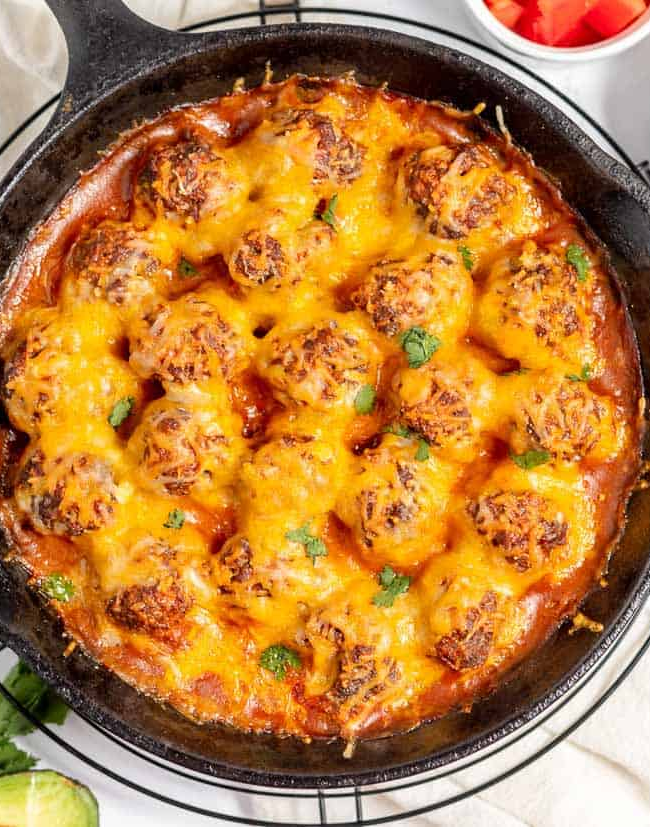 Cheesy mexican meatballs in a skillet.