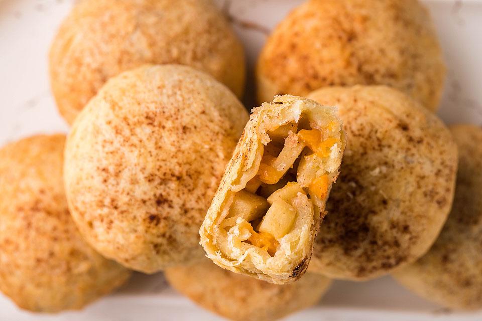 A close up image of a platter of Air Fryer Apricot Apple Cinnamon Dumplings. 