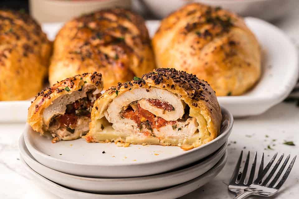 A sliced open Bruschetta Stuffed Chicken Breasts on a plate.