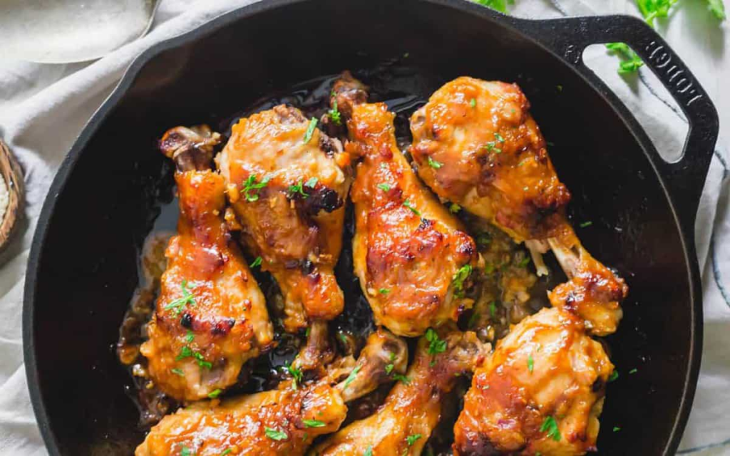 A pan of Maple Miso Chicken garnished with green onions.